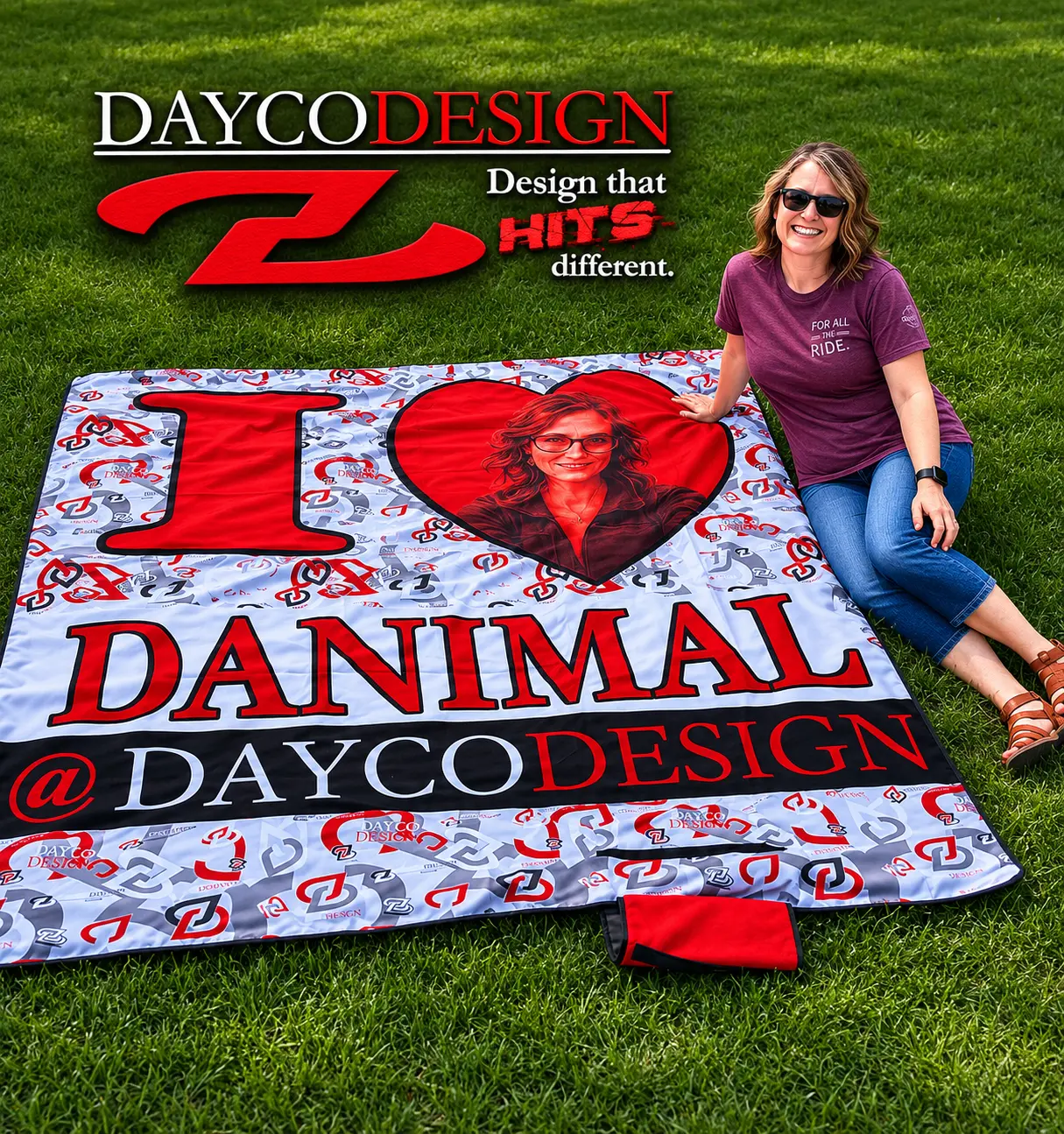 Custom "I ❤️ DANIMAL @ DAYCODESIGN" sublimated blanket laid out on grass, printed and shipped as a gift.
